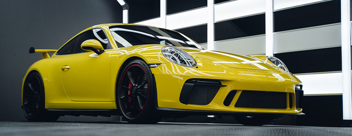 Yellow Porsche 911 GT3 in the Liquid R Mitcham workshop