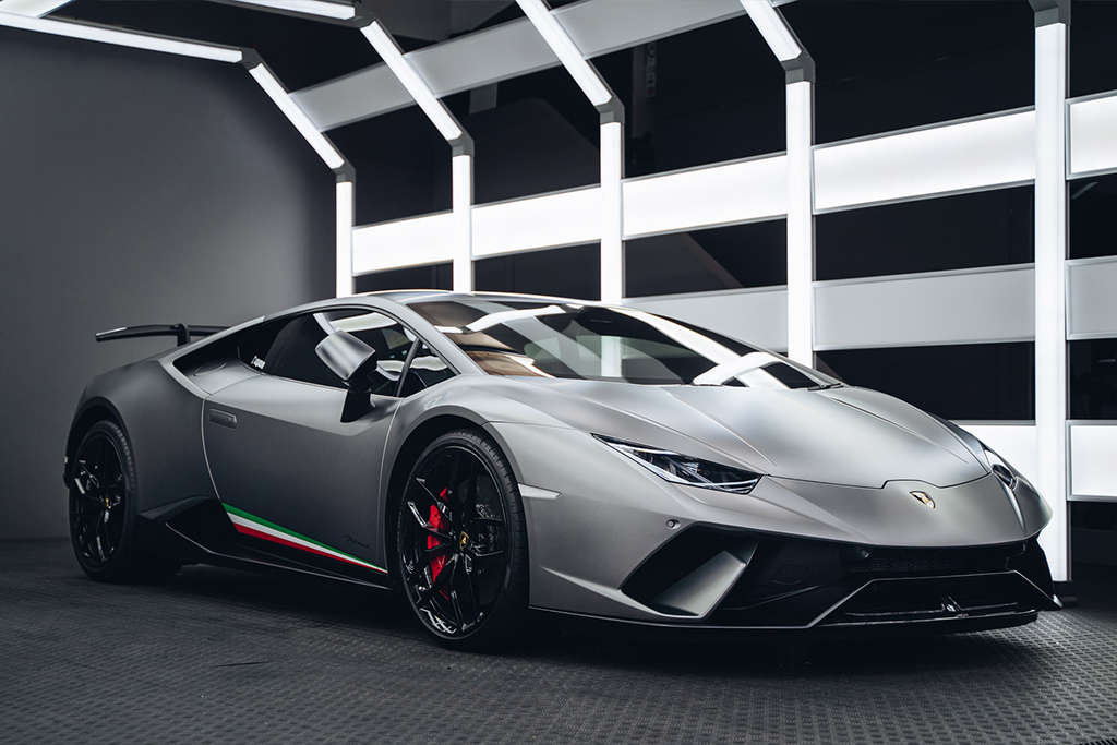Matte grey Lamborghini Huracan under workshop lighting at Liquid R